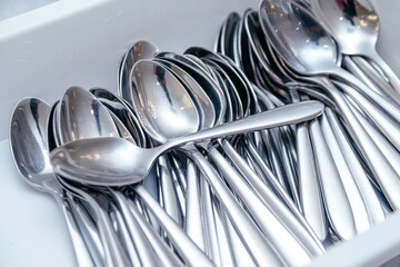A lot of metal spoons prepared for the banquet.