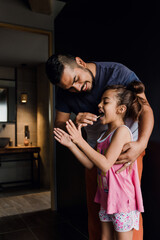 latin young father teaching to his daughter how to brush teeth at home in Mexico Latin America	