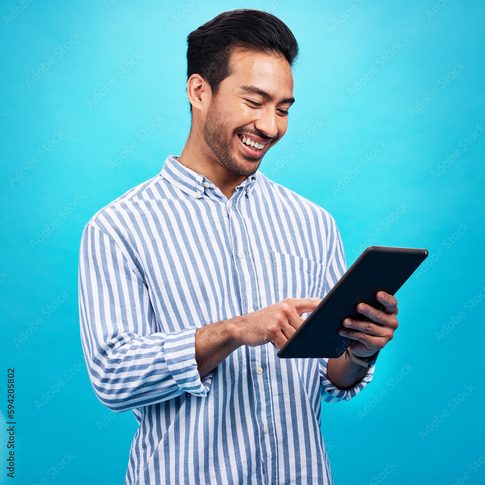 Aufkleber Tablet, man and smile in a studio on social media, internet and website app scroll. Happiness, isolated, and blue background with a male model reading a ebook on a digital networking application