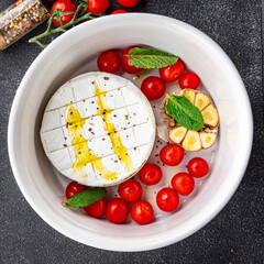 cheese baked tartiflette tomato, garlic and herbs meal food snack on the table copy space food background rustic top view