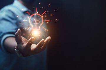 creativity new ideas and innovations hand holding light bulb and technology brain
