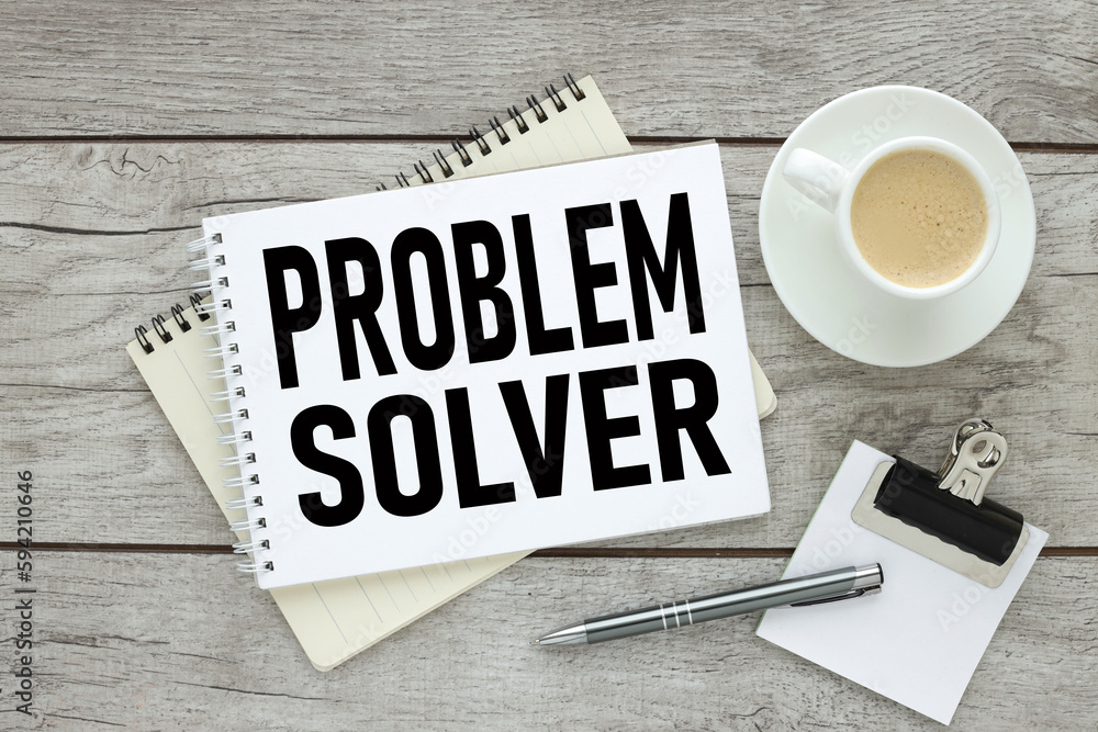 Poster problem solver, text on an open notebook near a cup of coffee. light wooden background