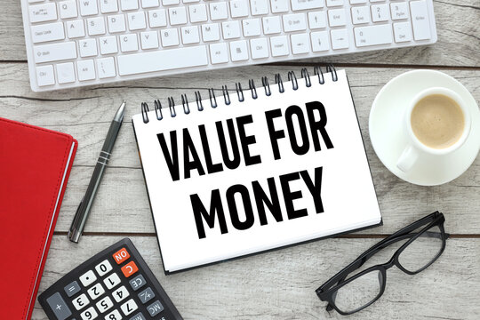 time value money. text on white paper near keyboard and red notepad. light wooden background