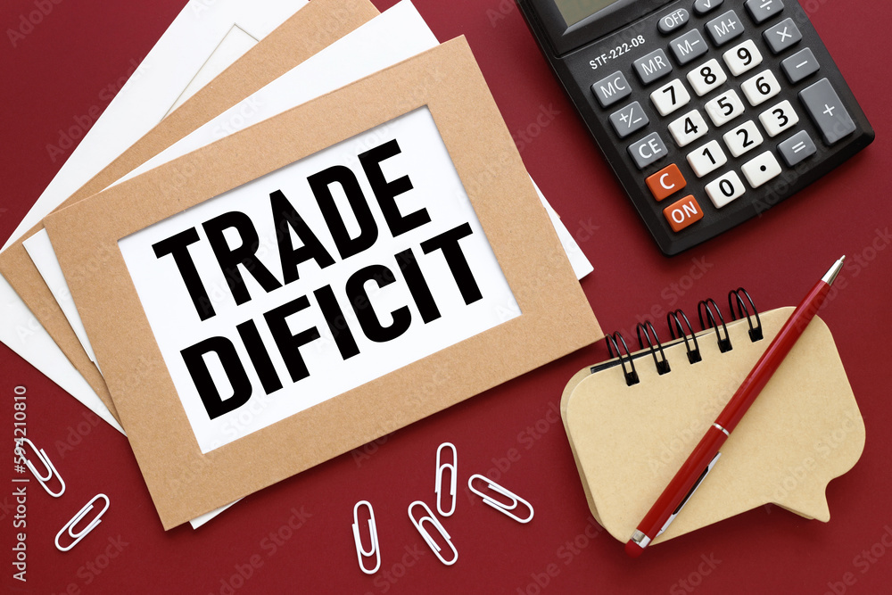 Poster trade deficit red background with notepad and calculator. text on white paper.