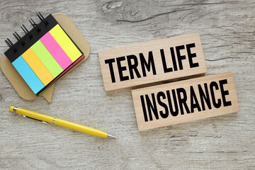 TERM LIFE INSURANCE text on wooden blocks near colorful stickers
