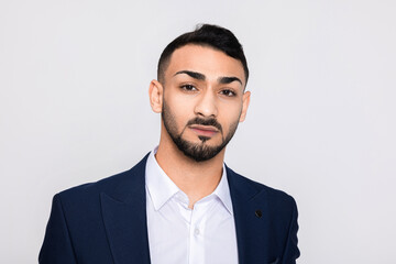 Serious turkish man buisnessman wearing ellegant suit looking at camera posing over grey background in studiio isolated showing serious concentrated emotiond in bad mood.