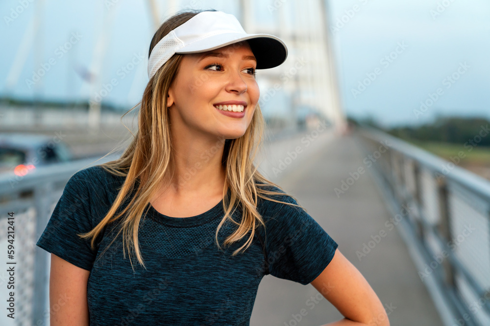 Wall mural Portrait of young fit attractive happy fitness woman in city. People healthy lifestyle concept.