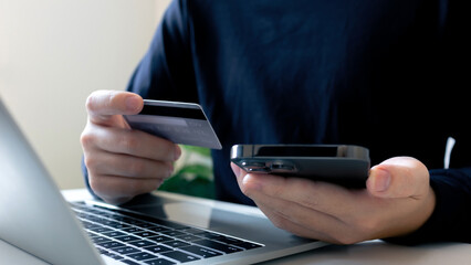 Ecommerce online shopping.Businessman holding credit card buying and selling on laptop from retail...