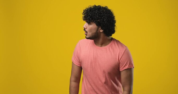 Confused Shocked Young indian man pointing with index finger to the side