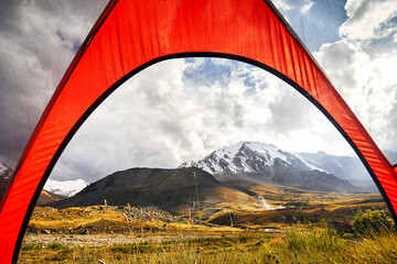 Orange tent in the mountain landscape