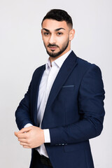 Delighted happy serious buisness man guy wearig smart suit standing on grey background in studio isolated looking at camera seriously banner with smart clever handsome man.