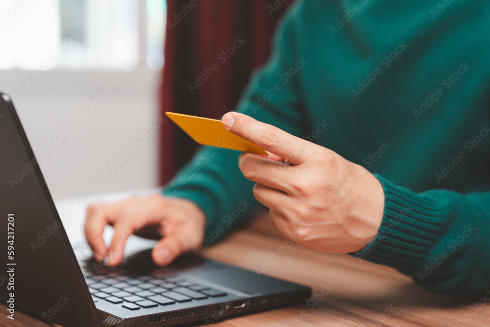 Poster young man using laptop to register via credit card to shop online. credit card secure online shoppin
