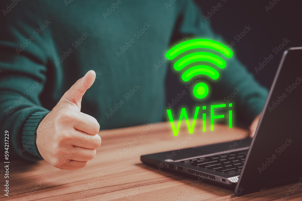 Poster Young man searching for wifi on his a computer laptop in the cafe. Concept of technology connectivity and connection problems to wifi by computer.