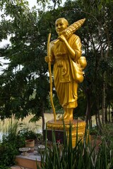 Golden statue of a monk, garden of Wat Thung Setthi, Khon Kaen, Isan, Thailand, Asia