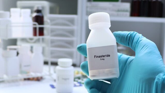 Finasteride pill in white bottle, pill stock, medical or pharmacy concept