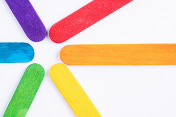 Multicolored boards in colors of rainbow on a white background. Background texture of colorful wooden planks