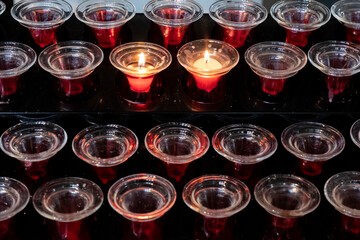 Red candles glowing in the dark. Taken in religious environment