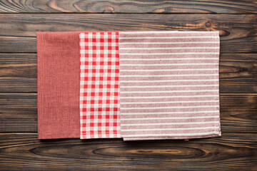 Obraz premium top view with red empty kitchen napkin isolated on table background. Folded cloth for mockup with copy space, Flat lay. Minimal style