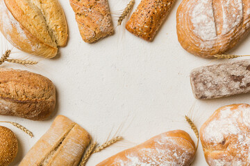 Homemade natural breads. Different kinds of fresh bread as background, top view with copy space