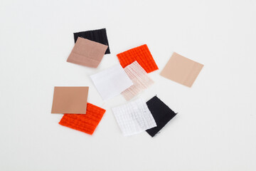 Pieces of colored fabric lined with a square on a white background	