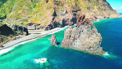 Aerial view of tall lava rocks in ocean, islet towers in Ribeira da Janela, Madeira, Portugal