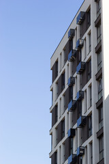 Architectural details of modern high apartment building facade with many windows and balconies