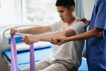 Obraz premium Physiotherapist Helping Patient While Stretching His Leg in bed