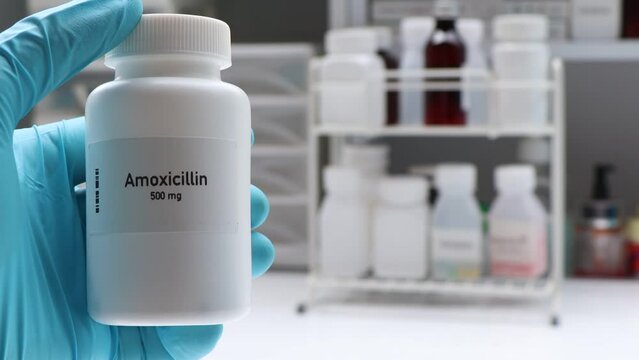 Amoxicillin pill in white bottle, pill stock, medical or pharmacy concept