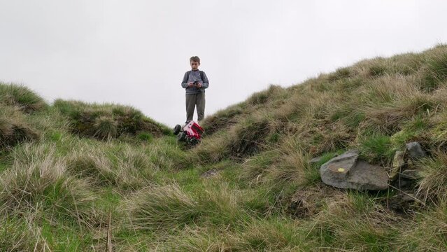 Young boy outdoors on the moors playing with his RC Car, Truck, 4 x 4
