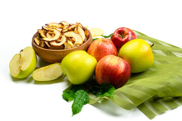 Dry apple slices in a bowl and fresh apples on white background. Dehydrated snacks of apple fruits....