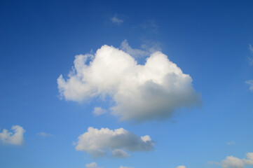 Naklejka na ściany i meble white fluffy clouds in the blue sky