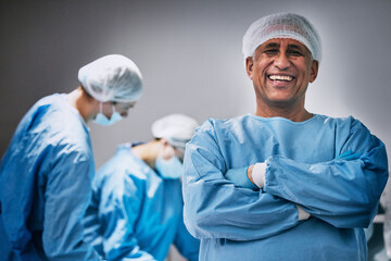 Theatre, portrait and man doctor with arms crossed for hospital teamwork, leadership and medical...