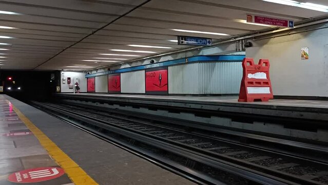Slow motion shot of an underground train approaching the underground platform