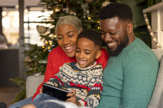 Family using a smartphone at Christmas time together 