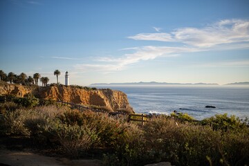 Lighthouse on the shore at sunset