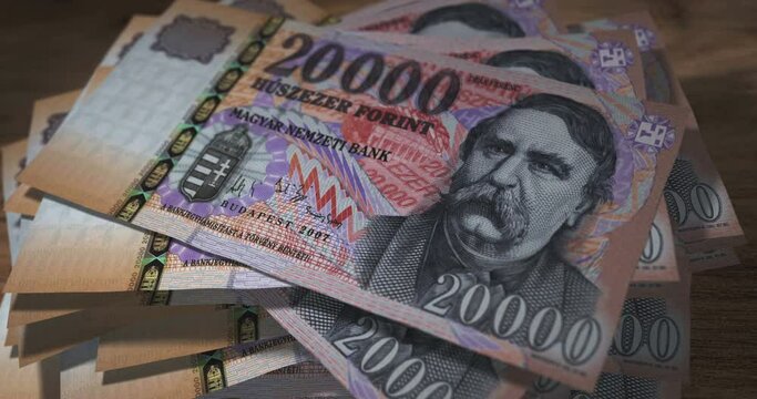 Hungarian Forint 20000 HUF banknotes falling on the table. Hungary currency paper notes count on stack. Timelapse of money counting. 3D concept.