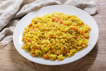 plate of pilaf with meat and vegetables