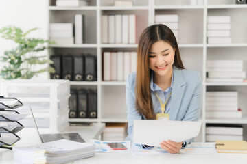 Asian businesswoman in formal suit in office happy and cheerful during using smartphone and working