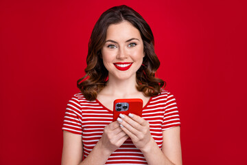 Photo of cute blogger lady browsing modern technology smartphone popular influencer blog isolated red color background