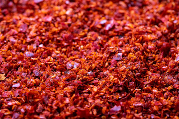 Red chili flakes. Crushed chili pepper or dried chili flakes background. Spices background. Close up