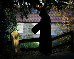 The grim reaper standing on a grave