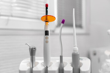 Close-up of dental instruments near the dental chair. Ultraviolet, saliva pump, water and air...