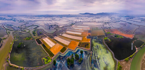 Long Dien sald field, Ba Ria Vung Tau province, Vietnam in salt making season in the April 2023. The salt field under the shimmering sunrise