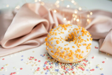 Sweet fresh donut in white glaze on the table