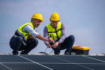 Engineers walking on roof inspect and check solar cell panel by hold equipment box and radio communication ,solar cell is smart grid ecology energy sunlight alternative power factory concept