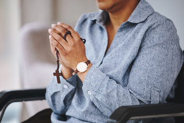 Praying hands, rosary and woman in a wheelchair in prayer, worship and praise closeup. God, pray and female asking, hope and relief of disability, thankful and gratitude to Jesus, faith and guidance