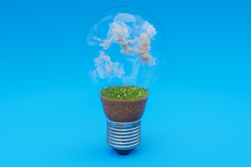 single lightbulb with green soil and clouds; renewable clean energy concept; 3D Illustration