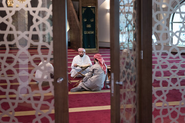 Read the Qur'an on the day of Ramadan. Group of Young Muslim people reading Qur'an at mosque