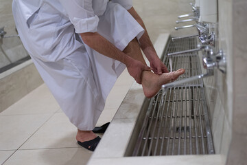 Man muslim perform ablution or wudu at the mosque. Washing before pray