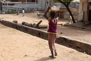 Poor negro village in Africa.Little African girl in a village.